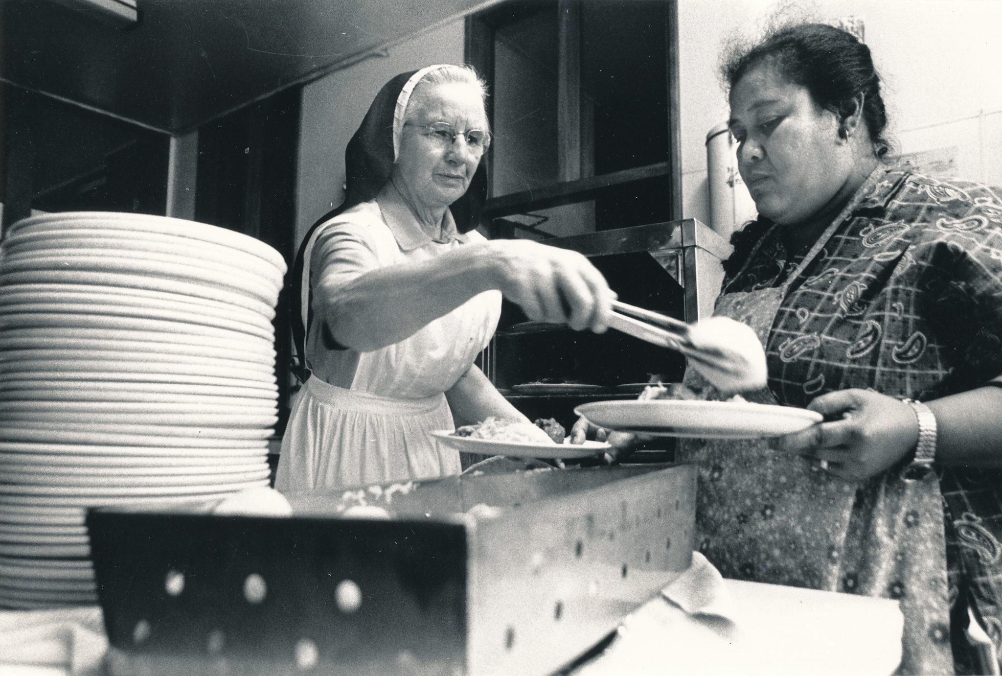 Sister serving the evening meal Soup Kitchen